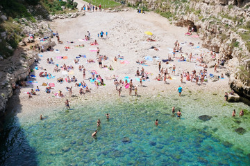 Vacationers on a stony beach on the Adriatic coast. Italy