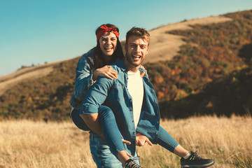 Happy young couple enjoys a sunny day in nature