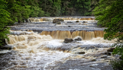 Dramatic shot of raging water cascading down river