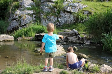 Children playing in a mountain cold river