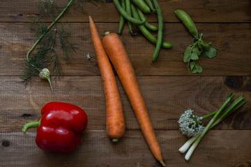 young fresh juicy carrots with vegetable vegetables on the table
