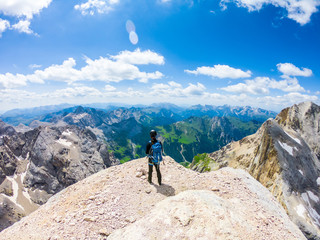 Fototapeta na wymiar Via ferrata Tofana di Mezzo climbers on the ridge in the Dolomites, Group of climbers on the mountain top, Dolomite Alps, Italy. Silhouette of people climbing the mountain. Tiny Man Big Landscape 