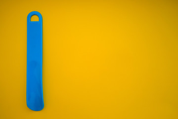 shoehorn on yellow background