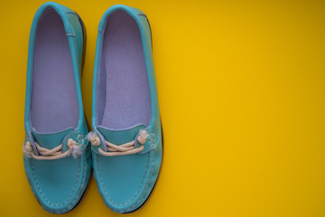 blue moccasins on a yellow background