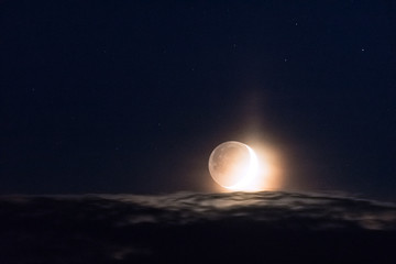 Fototapeta na wymiar Moon above clouds