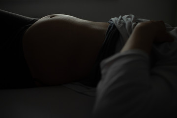 Belly of pregnant woman who rests
