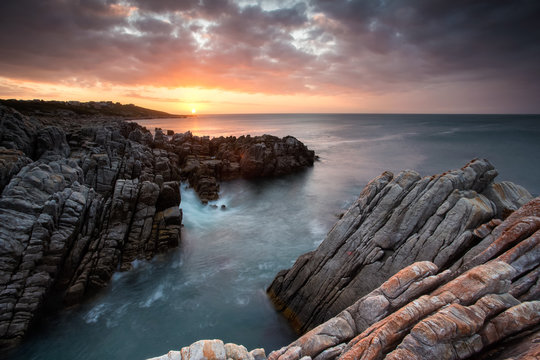 Beautiful sunset over the sandstone cliffs along the coastline of De Kelders in Gansbaai in the Overberg of south africa