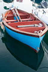 Fototapeta na wymiar Old fishing harbor with colorful wooden boats in old small city Giovinazzo near Bari, Apulia, Italy in early morning