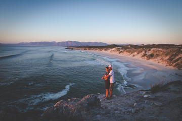 Fototapeta premium A couple looking over the ocean at th efamous De Kelders in Gansbaai in the Overberg region of south africa