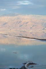 Sunset over lowest salty lake in world below sea level Dead sea, full of minerals near luxury vacation resort Ein Bokek, perfect place for medical treatments