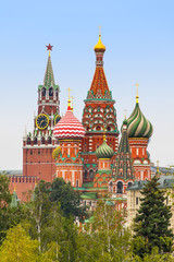 Fototapeta na wymiar Moscow Kremlin Spasskaya Tower, St. Basil's Cathedral around the trees