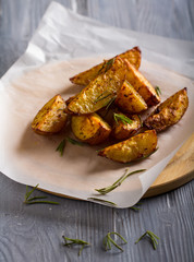 grilled potatoes rosemary wooden background
