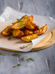 grilled potatoes rosemary wooden background
