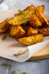 grilled potatoes rosemary wooden background