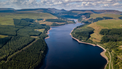 Aerial drone view of low water levels in Pontsticill Reservoir, Brecon Beacons during a summer...