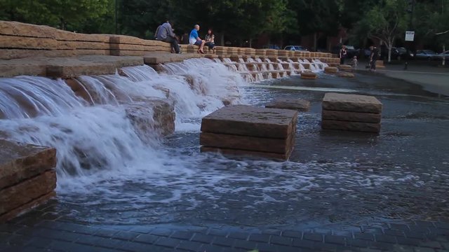 Portland, Oregon, June 25, 2015 &ndash; People relax by the unique fountain at Jamison Square Park in the Pearl District