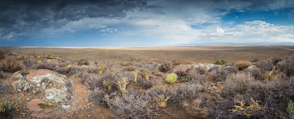 Panoramic views over the Tankwa Karoo Desert with dramatic thunderclouds in the sky