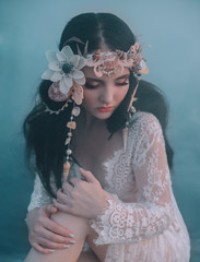 Close-up portrait - makeup of a river nymph, in gentle green, yellow, peach hues. The brunette girl...