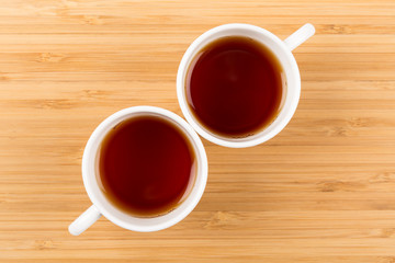 Good Morning, Two White Cups of tea isolated on a wooden background shot from above, breakfast
