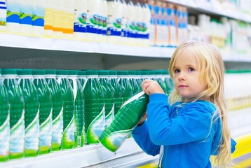 Little Girl in a Supermarket Buying Milk