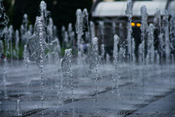Naklejka na ściany i meble A spray of water in the fountain