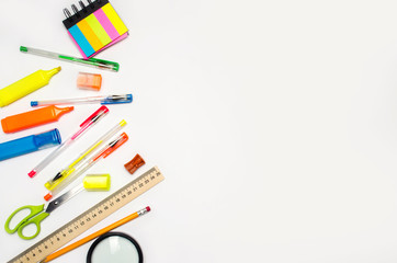 school accessories on a white background. stationery. back to school. concept of education. desk. color pens, pencils, ruler, alarm clock. place for text. copy space. view from above. flat lay