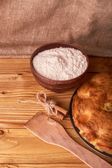 apricot pie and a bowl with flour and other ingredients and tools table