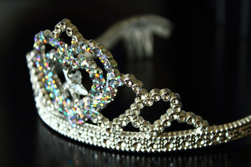 Plastic shiny crown for children. Close-up. Background.