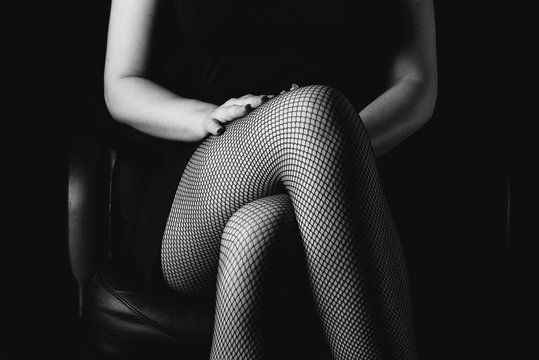 sexy women's legs in black fishnet stockings texture. woman knee in fishnet stockings