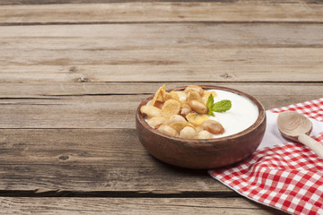 a bowl of yoghurt over wooden table