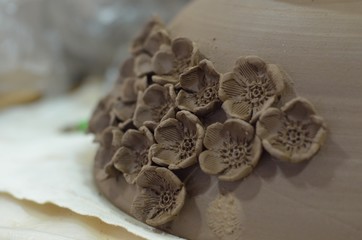 Clay pot decoration with flowers after a potter's wheel