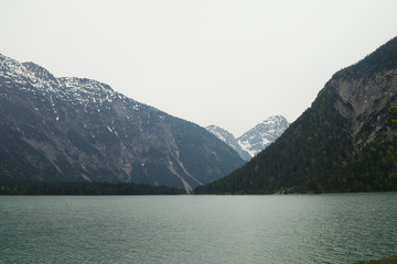 Majestic emerald mountain lake in Switzerland on the background of the Alps