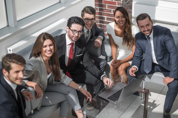 senior businessman and business team sitting in the lobby of the modern office.