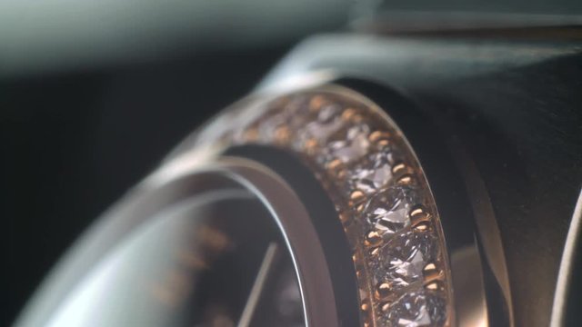 Luxury expensive fashion gold watches with sapphires and diamons.Arrows ticking. Close up 4k macro shot.
