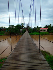 Suspension bridge across river.