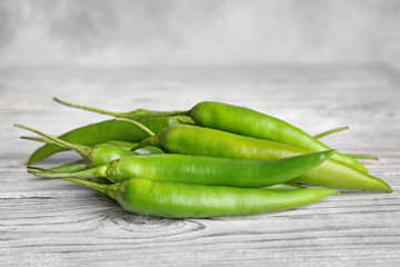 Pile of ripe chili peppers on wooden table