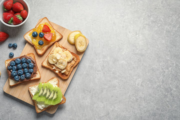 Flat lay composition with toast bread and different toppings on grey background