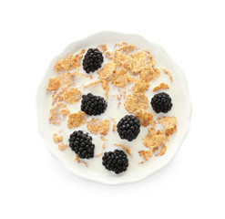 Bowl with flakes, milk and berries on white background. Healthy grains and cereals