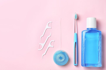 Flat lay composition with manual toothbrush and oral hygiene products on color background