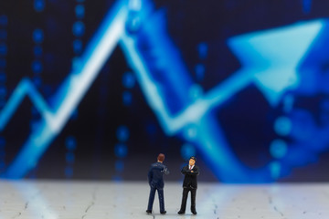 Miniature people: Businessman stand front of dashboard, display graphs, profit margins of ...