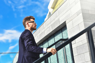 Businessman walking upstairs in an office park.