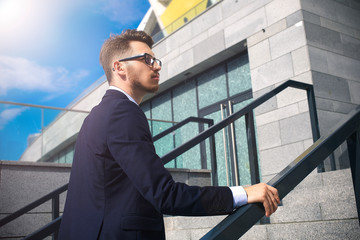 Businessman walking upstairs in an office park.