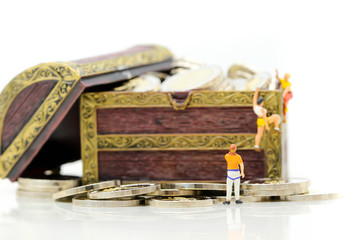 Miniature people : Climber found the treasure of gold coins,Concept of the path to purpose and success.