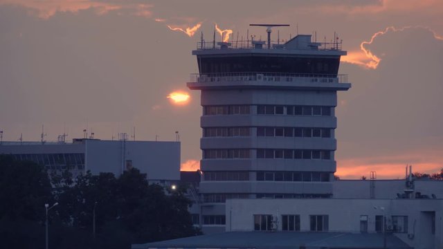 Air traffic radar control tower after thunderstorm at sunset
