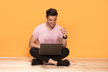 Smiling young man with laptop computer.