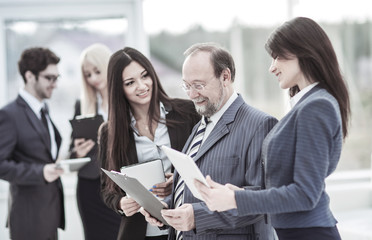 successful businessman and business team discussing business documents standing in the lobby of the office