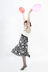 happy young woman holding red balloons. photo with copy space