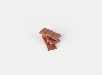 pieces of milk chocolate with nuts isolated on white