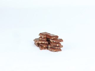 pieces of dark chocolate with nuts isolated on white.photo with copy space