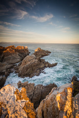 Fototapeta na wymiar Wide angle landscape image of rock formations and the indian ocean along the Garden Route coast of South Africa
